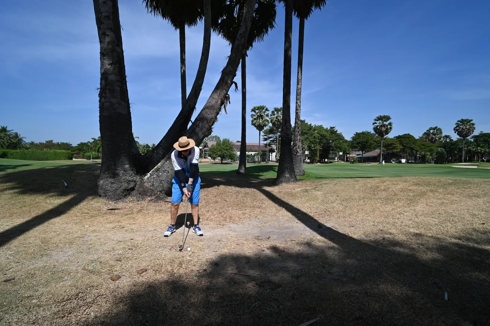 Golfer on a sunny Florida fairway representing the Ron Garl championship course at Heritage Springs in Trinity